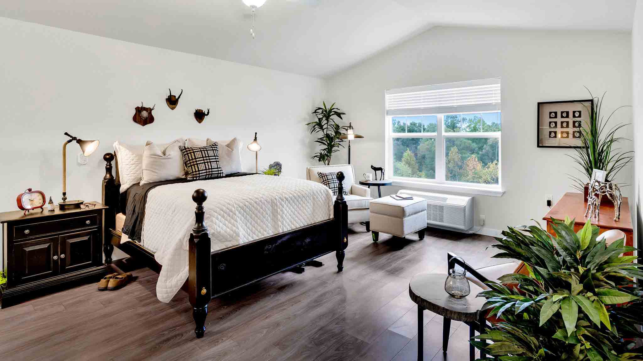 A furnished bedroom in a Whispering Pines apartment