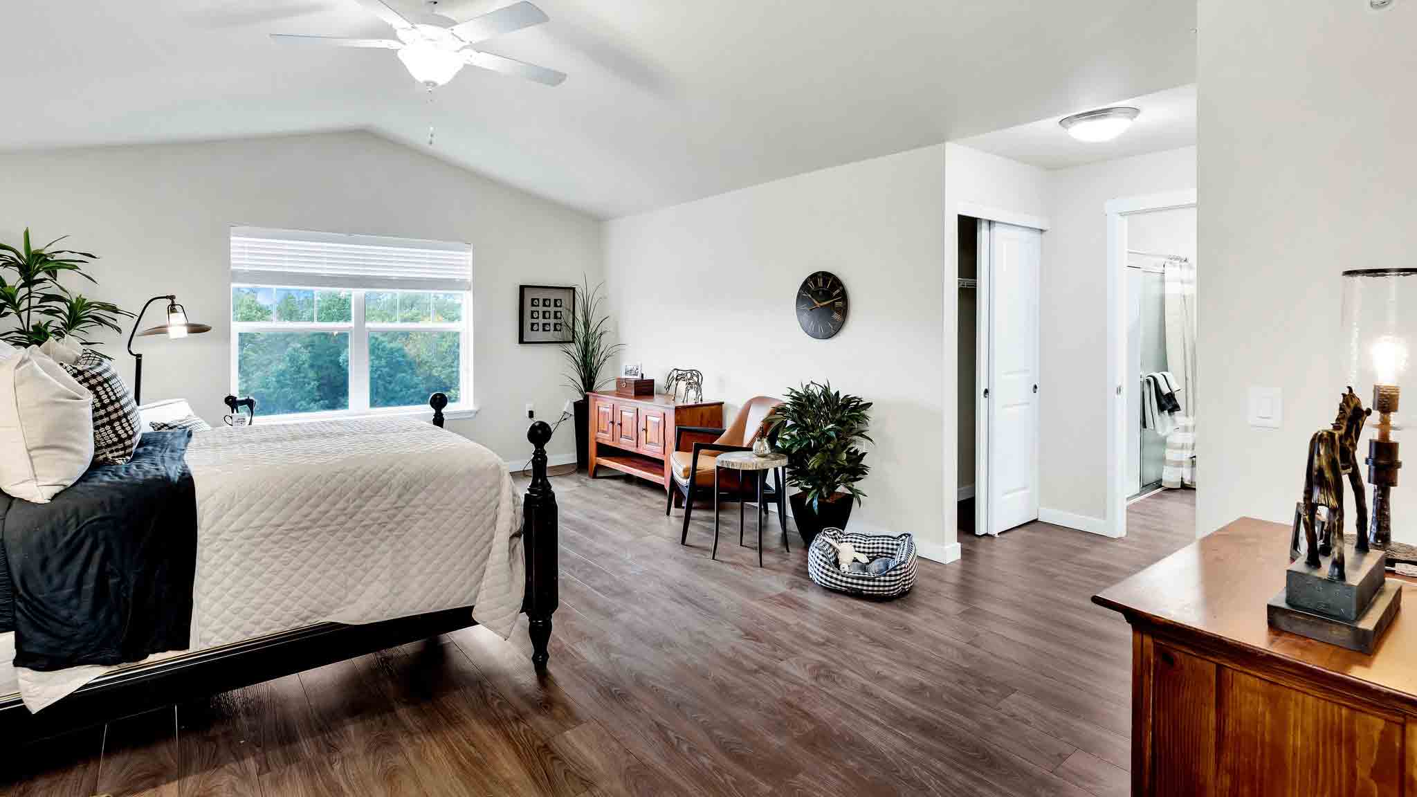 A furnished bedroom in a Whispering Pines apartment