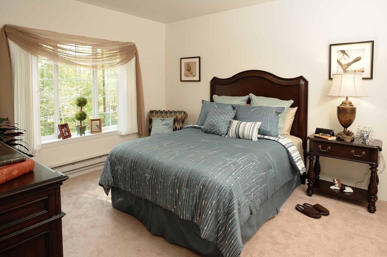 A furnished bedroom in a Whispering Pines apartment