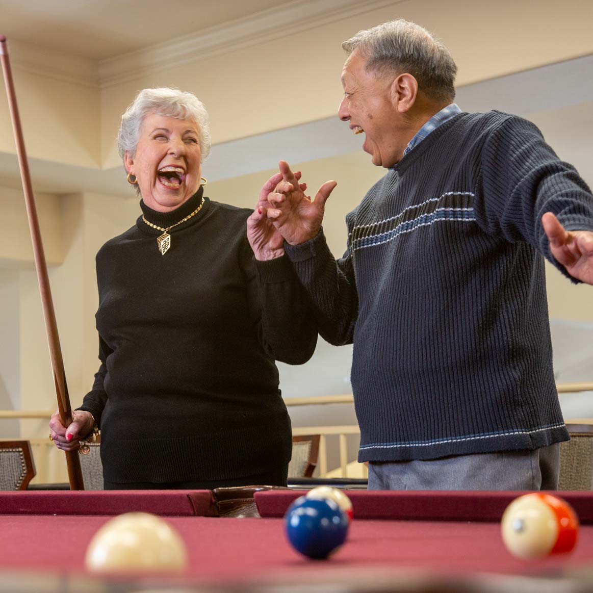 Residents playing billiards at Whispering Pines